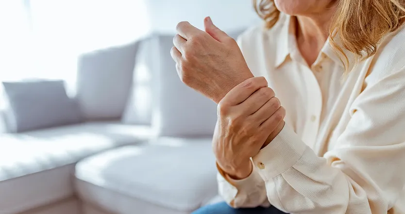 Woman grabbing wrist in pain