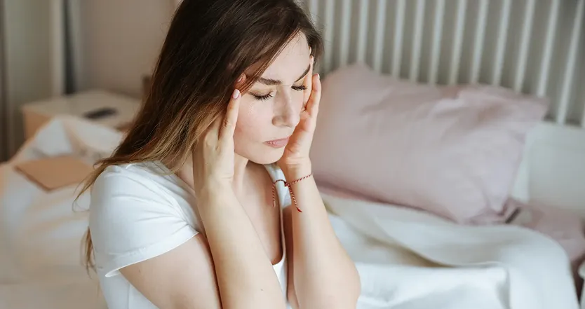Woman rubbing temples