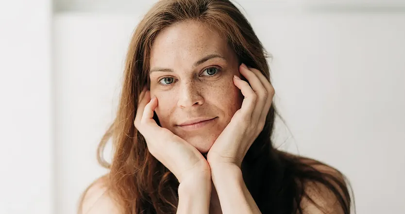 Woman with hands on cheeks